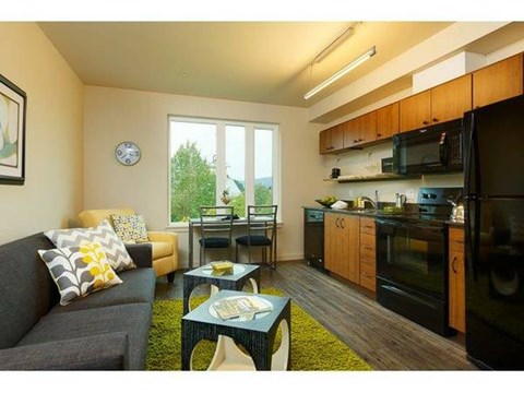 A kitchen with black appliances and wooden cabinets is shown.